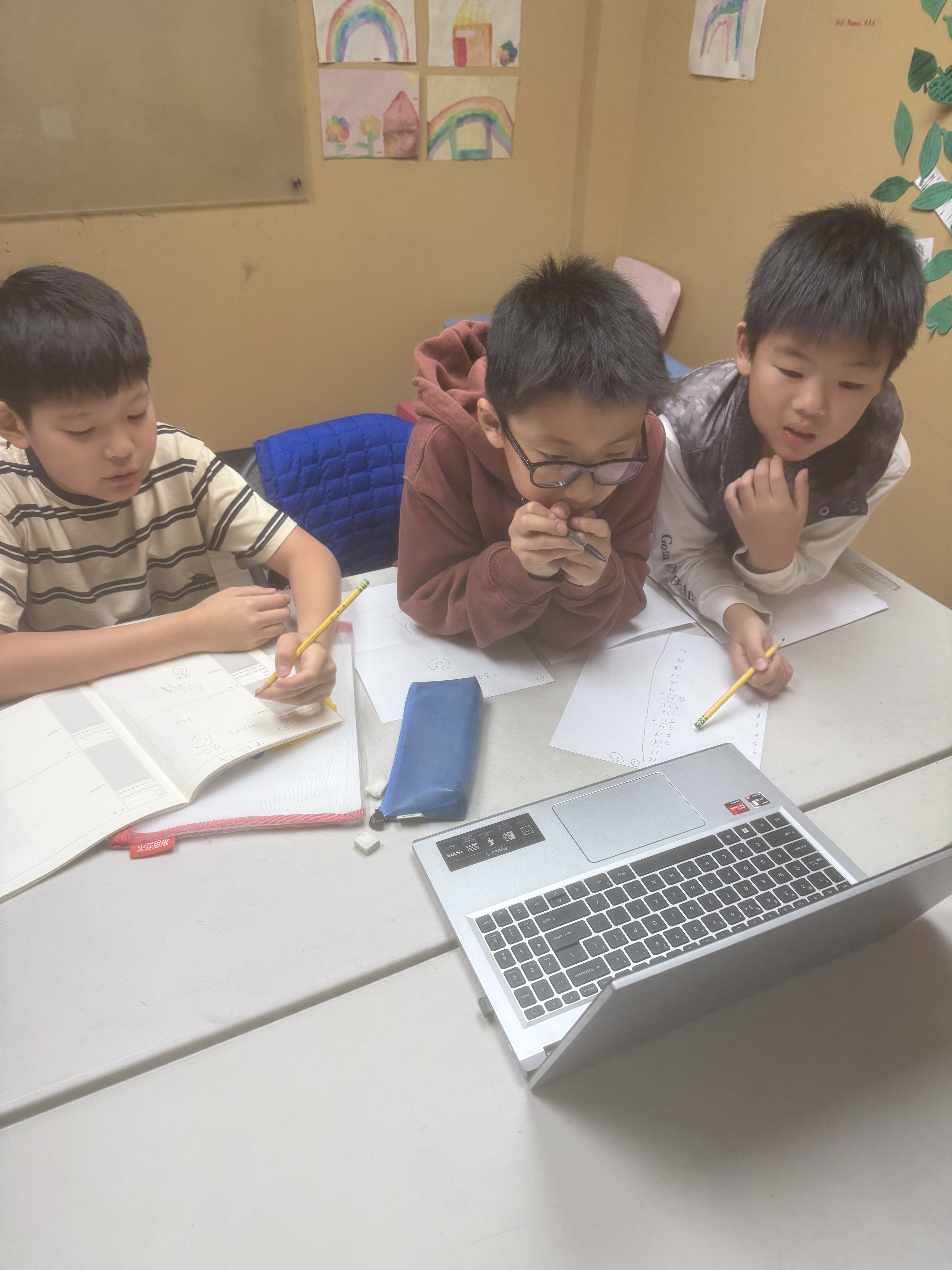 Two students carefully filling in Math Kangaroo answer sheets